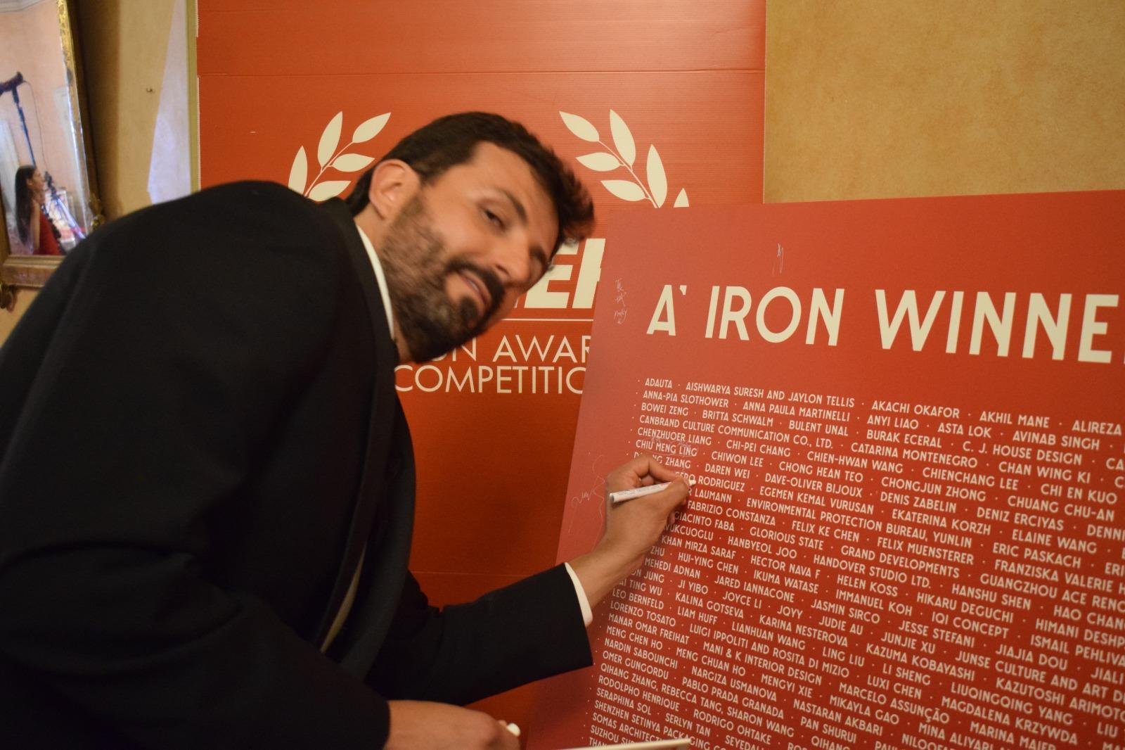 Eduardo Acero Rodriguez signing the A' Design Award winners wall in Como, Italy.