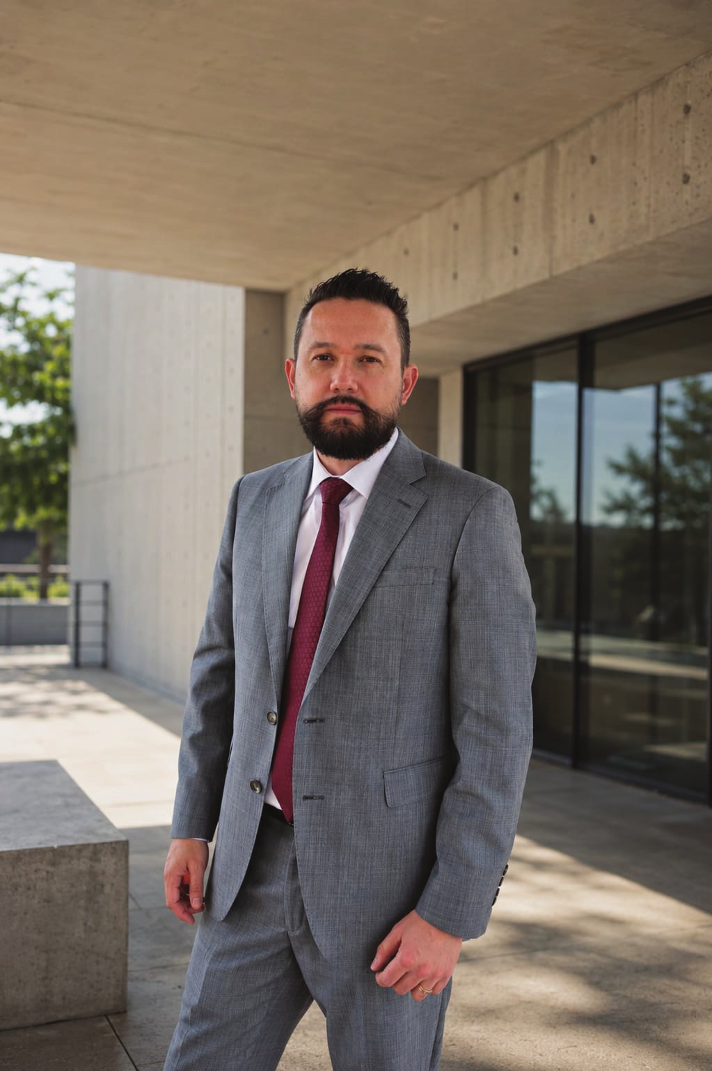 Alejandro Ardila, architect and drafter at Sky Up Design, photographed outside a concrete building.